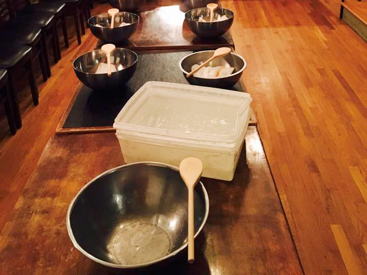 class set up with bowls and wooden spoons to make mozzarella