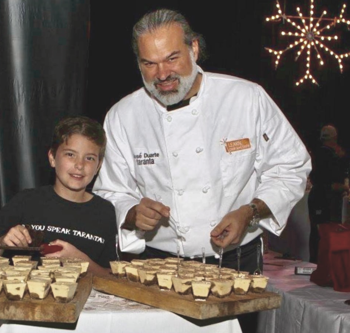 chef owner jose duarte with his son Diego serving tiramisu