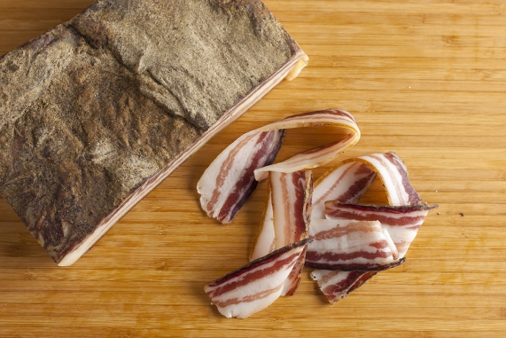 a piece italian bacon pancetta showing lard lines